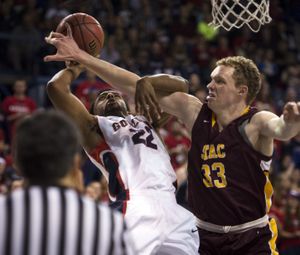 Gonzaga's Byron Wesley (22) is fouled by St. Thomas Aquinas' Sam Berlin (33) during the first half of a NCAA men's college basketball game, Saturday, Nov. 22, 2014, at the McCarthey Athletic Center.