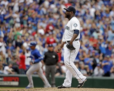 Mariners relief pitcher Fernando Rodney, right, can only wait as Toronto’s Ezequiel Carrera rounds the bases. (Associated Press)