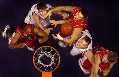 Cougars (from left in white) Caleb Forrest and Chris Henry battle Wildcats (from left) Mustafa Shakur, Ivan Radenovic and Kirk Walters. WSU had trouble underneath scoring and rebounding.
(Brian Plonka / The Spokesman-Review)
