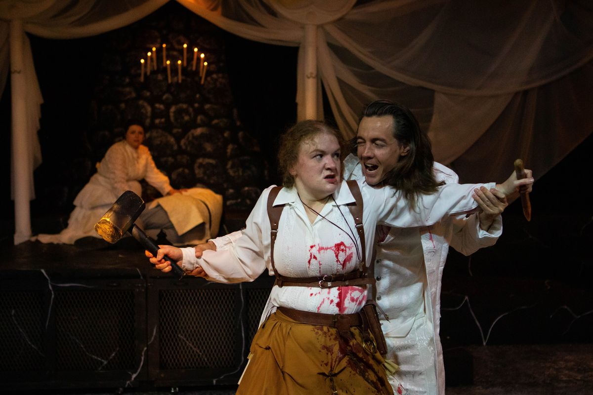 Ethan Williams as Dracula fights with Lani Call as Doctor Van Helsing in Spokane Civic Theatre’s production of “Dracula,” which opens this weekend in the Firth J. Chew Studio Theatre. In the background are Shakyla Garcia Davidson as Mina Harker and Nicholas Roy Morgan III playing Doctor George Seward.  (Emma Ostrom)