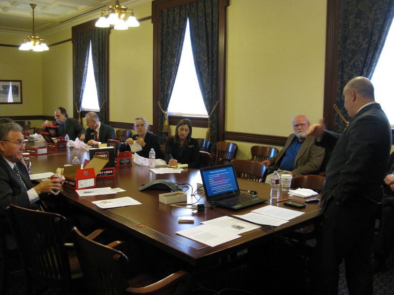 Thirteen Idaho lawmakers listen to a luncheon talk at the Statehouse on Thursday from the Rev. Shahram Hadian (Betsy Russell)