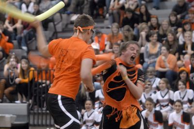 Post Falls  senior Brady Ryan yells as he pummels sophomore Alex Carey during the “noodle” fights during the Spirit Competition  before the game between Post Falls and Lakeland. (J. Rayniak / The Spokesman-Review)