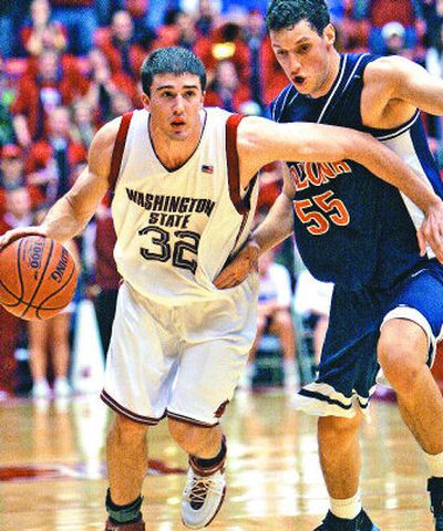 
Daven Harmeling drives past Arizona' Ivan Radenovic but does the most damage with his jump shot. 
 (Associated Press / The Spokesman-Review)