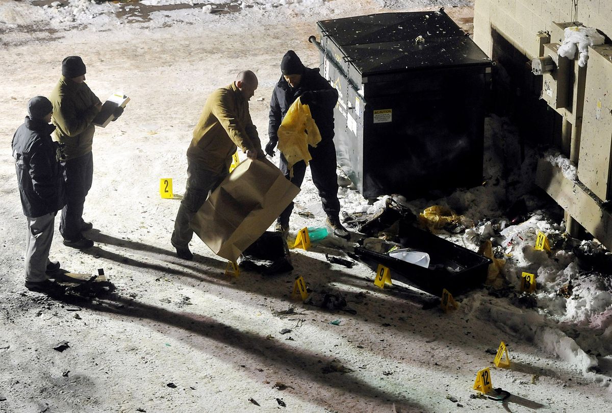 Investigators inspect the debris  that was left following the detonation of suspicious packages placed in downtown Aspen.  (Associated Press / The Spokesman-Review)