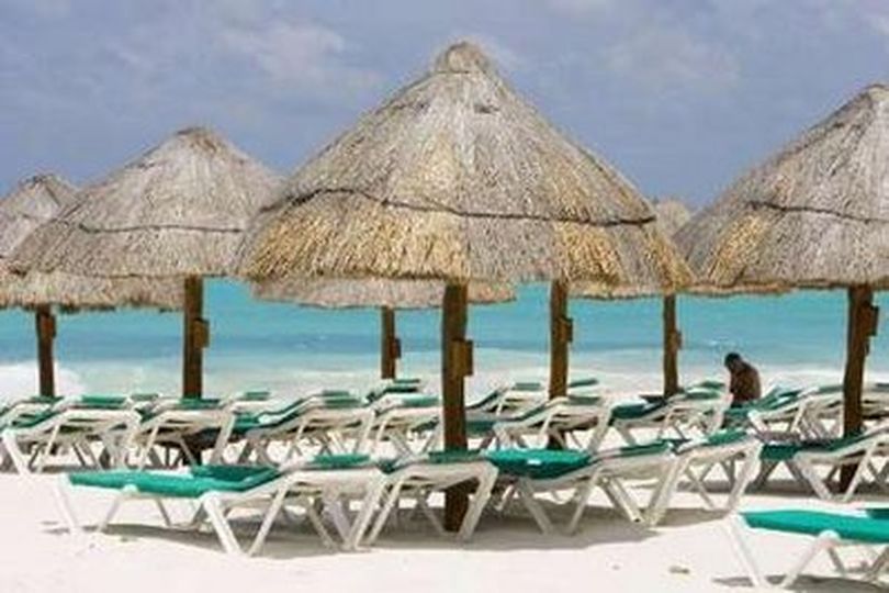 A tourist sits among empty beach chairs in Cancun May 1, 2009. The flu outbreak is hitting Mexico's tourism industry, which accounts for roughly 8 percent of the economy. Many groups of foreign tourists and students left the country earlier than planned due to the spread of influenza A (H1N1), formerly referred to as swine flu. REUTERS/Gerardo Garcia (MEXICO HEALTH TRAVEL) (The Spokesman-Review)
