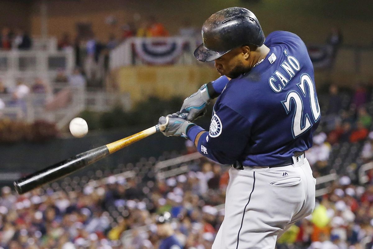 Robinson Cano of the Mariners hits an RBI single off Minnesota Twins pitcher Kyle Gibson during the third inning of Friday night’s game in Minneapolis. (Jim Mone / Associated Press)