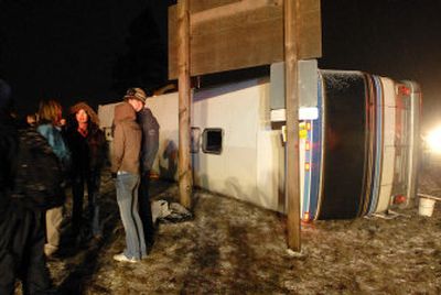 
Students mill around a Silver Eagle charter bus that tipped over Wednesday on U.S. Highway 95 in Hayden. The bus was carrying 41 Lake City High School students and two teachers returning from a field trip to Schweitzer Mountain Resort near Sandpoint. The students are in the school's life sports class. 
 (Jesse Tinsley / The Spokesman-Review)