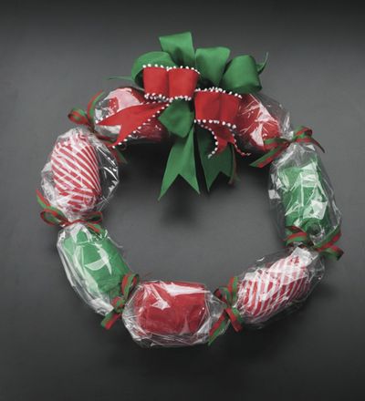  A holiday wreath made of individually wrapped gifts.