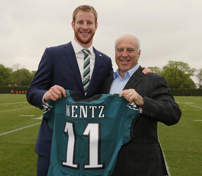 Carson Wentz, left, first-round draft pick of the Philadelphia Eagles, holds up his jersey with team owner Jeffrey Lurie before a news conference at the team's practice facility. (RICH SCHULTZ / Assoicated Press)