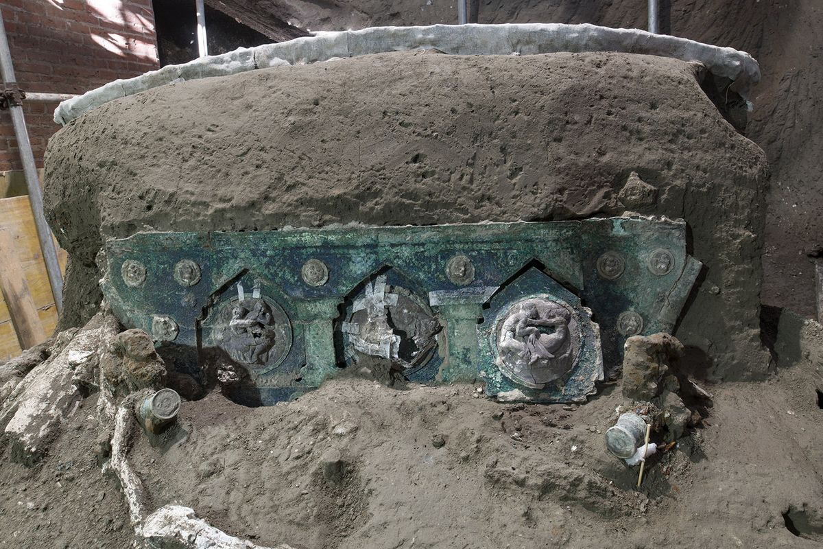 A view of a chariot, with its iron elements, bronze decorations and mineralized wooden remains, that was found in Civita Giuliana, north of Pompeii. Officials at the Pompeii archaeological site near Naples on Saturday, Feb. 27, 2021, announced the first-ever discovery of an intact ceremonial chariot, one of several important discoveries made in the same area outside the park following an investigation into an illegal dig.  (HOGP)