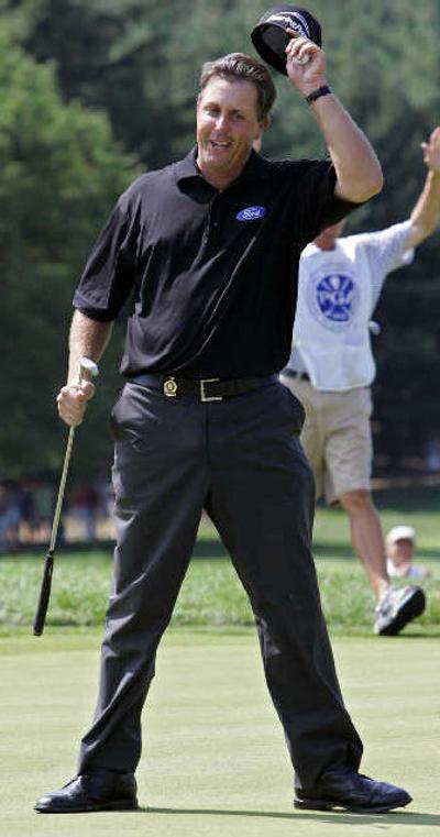 
Phil Mickelson celebrates after sinking the winning putt at the PGA. 
 (Associated Press / The Spokesman-Review)