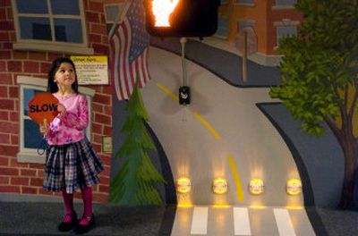
Maria Guglielmo, 4, holds a sign to tell traffic to slow down at the Mobius Kids exhibit 