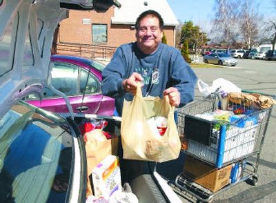 
Always smiling, Sam Petersen volunteers on a regular basis at the Spokane Valley Food Bank. He recently received an award for the Self-Advocate of the Year from the Arc of Spokane for his work. 
 (J. BART RAYNIAK / The Spokesman-Review)