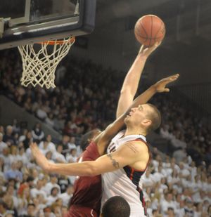 Josh Heytvelt of Gonzaga takes a shot across the face as he goes to the hoop against Loyola Marymount. (Christopher Anderson / The Spokesman-Review)