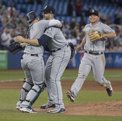 Seattle Mariners starting pitcher James Paxton, center, celebrates with teammates after throwing a no-hitter against the Toronto Blue Jays in a baseball game Tuesday, May 8, 2018, in Toronto. (Fred Thornhill / Canadian Press via AP)