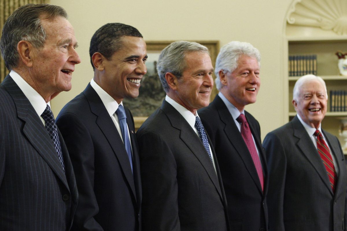 President George W. Bush, center, poses Jan. 7, 2009, with President-elect Barack Obama, second left, and former presidents, George H.W. Bush, left, Bill Clinton, second right, and Jimmy Carter, right, in the Oval Office of the White House in Washington. Bush has died at age 94. Family spokesman Jim McGrath says Bush died shortly after 10 p.m. Friday, Nov. 30, 2018, about eight months after the death of his wife, Barbara Bush. (J. Scott Applewhite / AP)