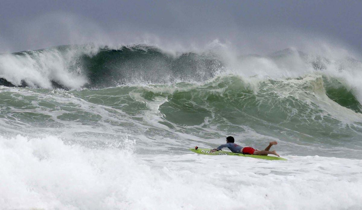 Mitchell Nugent paddles a board toward waves near Crystal Beach as Tropical Storm Gordon churns the Gulf of Mexico in Destub, Fla., Tuesday Sept. 4, 2018. (Devon Ravine/Northwest Florida Daily News / Associated Press)