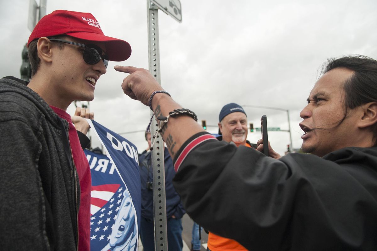 Jacob Johns, right, of Spokane, argues with a Trump supporter, left, in Spokane on Tuesday. Protesters lined the streets in preparation for Vice President Mike Pence’s campaign stop in support of Congresswoman Cathy McMorris Rodgers. (Kathy Plonka / The Spokesman-Review)
