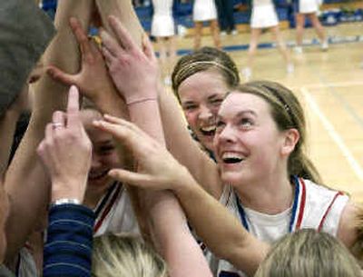 
Coeur d'Alene's Jenna DeLong, right and Jenna Griffitts, second from right celebrate the Vikings 47-30 victory over Lake City. 
 (Tom Davenport / / The Spokesman-Review)