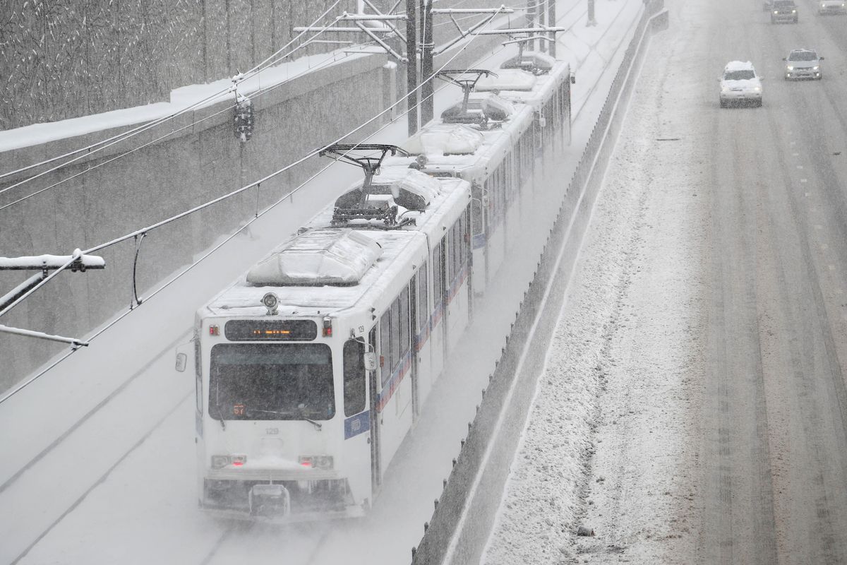 A light rail train whips down the tracks parallel to Interstate 25 as motorists struggle to guide their vehicles down the highway as a winter storm sweeps over the intermountain West Friday, Feb. 7, 2020, in Denver. Forecasters predict that the storm will dump from one to three feet of snow in parts of Colorado before moving out Saturday to the Plains states and, in the process, clearing a path for another storm to hit the region Sunday. (David Zalubowski / Associated Press)