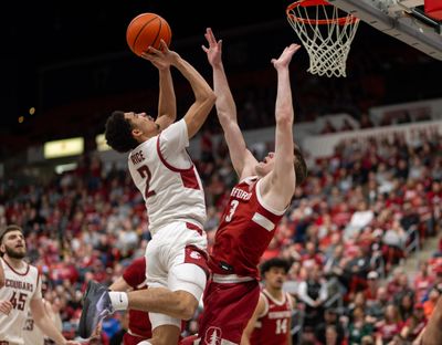 Washington State guard Myles Rice puts up a shot under pressure from Stanford guard Michael Jones on Feb. 17 at Beasley Coliseum in Pullman.  (Geoff Crimmins/For The Spokesman-Review)
