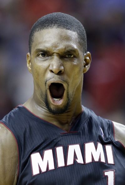 Miami’s Chris Bosh celebrates after hitting a late 3 to lead the Heat past the Trail Blazers.