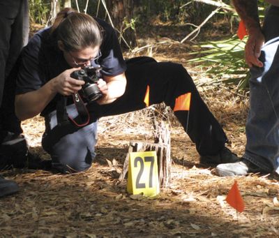  Diane Robinson, of the American Humane Association, photographs a staged crime scene recently at the University of Florida in Gainesville, Fla.  (Associated Press)