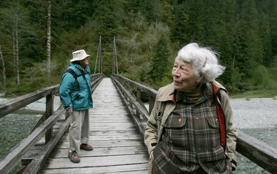 As the Baker River rushes by, Polly Dyer, right, and Patrick Goldsworthy survey an area at the edge of North Cascades National Park on May 12. Dyer and Goldsworthy helped found the park, which is now 40 years old. Seattle Times (Ken Lambert  Seattle Times / The Spokesman-Review)