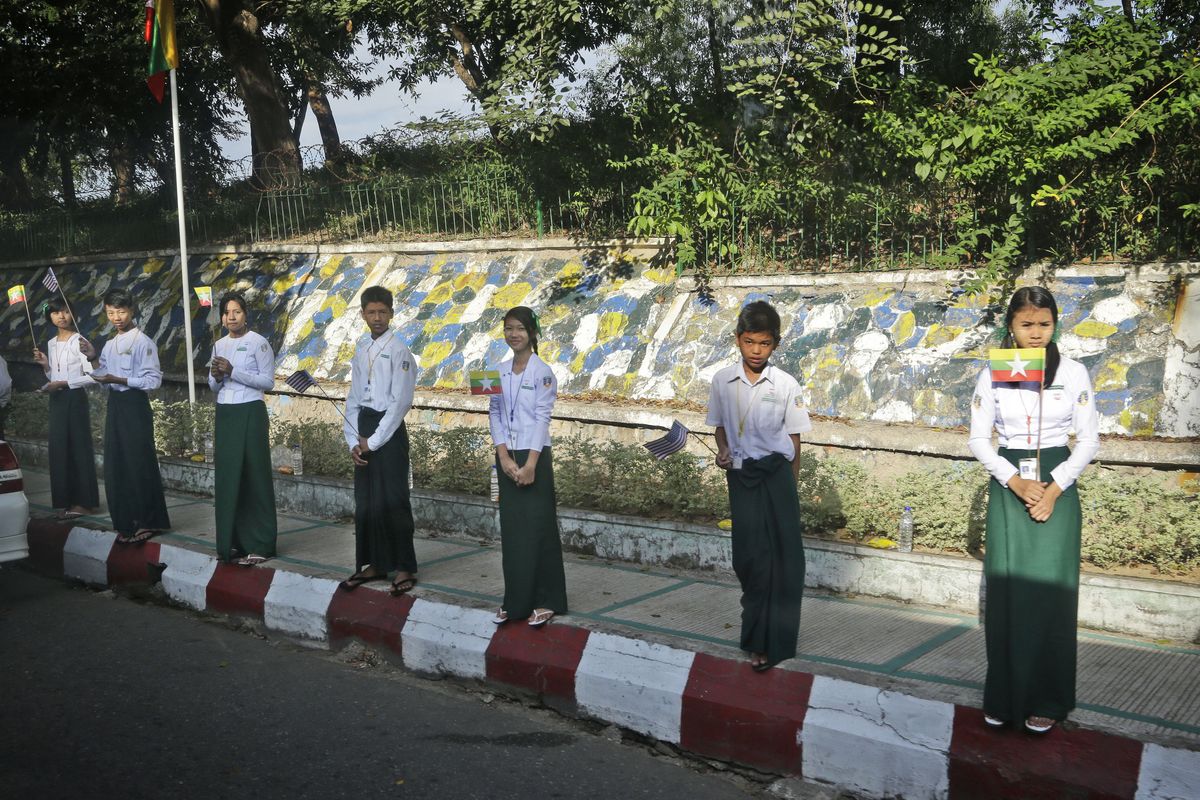Young boys and girls line the streets waving flags along the motorcade route in anticipation of the arrival of U.S. President Barack Obama, in Yangon, Myanmar, Monday, Nov. 19, 2012. (Pablo Monsivais / Associated Press)
