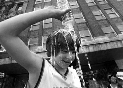 
Derrick Rabideaux, of the Valley All Starz, cools off during last year's Hoopfest downtown, where temperatures are usually warmer than in immediately surrounding areas. 
 (File / The Spokesman-Review)