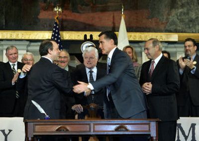 
Massachusetts Gov. Mitt Romney, right, shakes hands with Mass. Health and Human Services Secretary Timothy Murphy on  Wednesday after signing into law a landmark health-care bill. 
 (Associated Press / The Spokesman-Review)