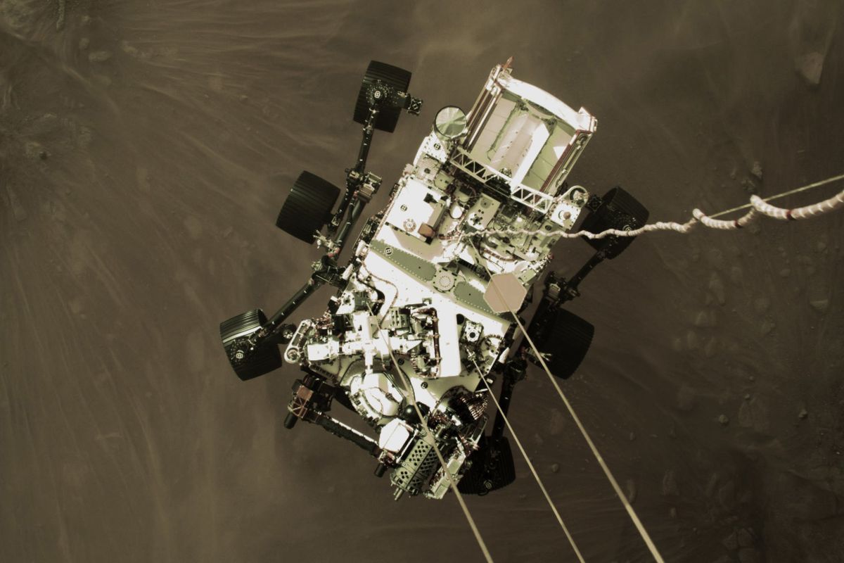 A photo provided by NASA on Thursday shows the Perseverance rover just 6 ½ feet from the ground during its powered descent to the surface of Mars.  (HOGP)
