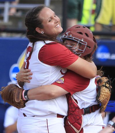 Alabama pitcher Jaclyn Traina and catcher Molly Fichtner celebrate after eliminating Oregon in Women’s CWS. (Associated Press)