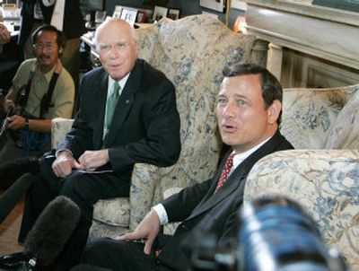 
Sen. Patrick Leahy, D-Vt., left, ranking member of the Senate Judiciary Committee, and Supreme Court nominee John Roberts, right, look toward reporters asking  questions during a photo opportunity in Leahy's office on Monday. 
 (Associated Press / The Spokesman-Review)