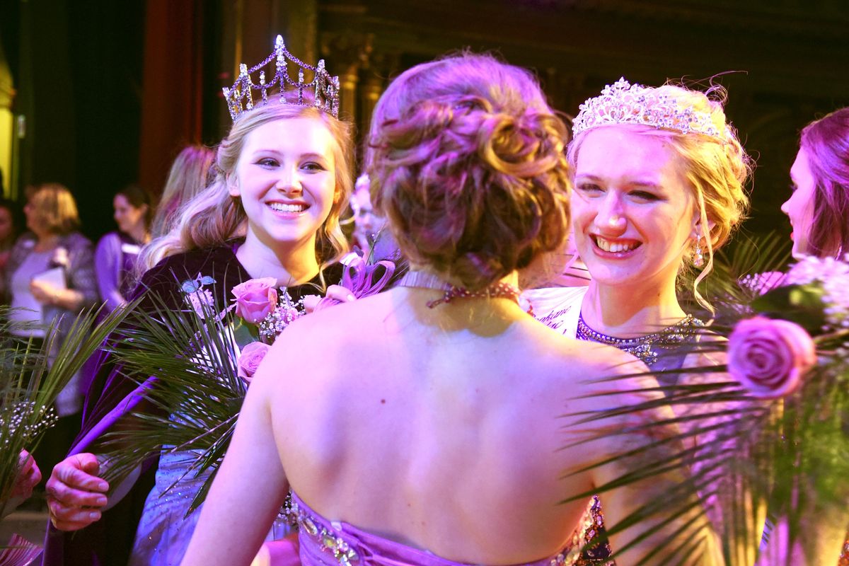 A family and friends crowd the stage after the cornonation, new 2016 Lilac Festival queen Megan Paternoster, left, of Freeman High School and princess Mandi Edlin, right, are congratulated by candidate Hannah Workman (back turned) after the announcement of the Lilac Festival queen and court Jan. 31, 2016 at the Bing Crosby Theater in Spokane. (Jesse Tinsley / The Spokesman-Review)