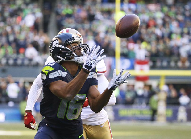 In this Nov. 22, 2015 photo, Seattle Seahawks wide receiver Tyler Lockett catches a pass for a touchdown in front of San Francisco 49ers strong safety Jimmie Ward. (Elaine Thompson / Associated Press)