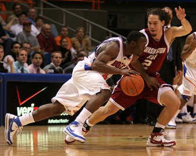 
Boise's Anthony Thomas drives on Derrick Low. Low's second-half scoring keyed a Cougars rally.Special to 
 (Steve Conner Special to / The Spokesman-Review)