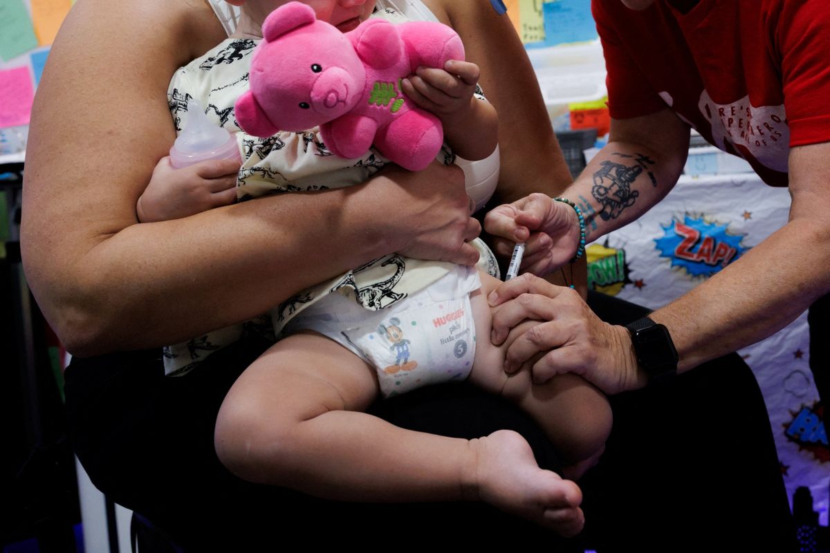 A 1-year-old receives a dose of Moderna Spikevax (COVID-19 vaccine, mRNA) on Oct. 2 at Skippack Pharmacy in Schwenksville, Pa.  (Reuters)