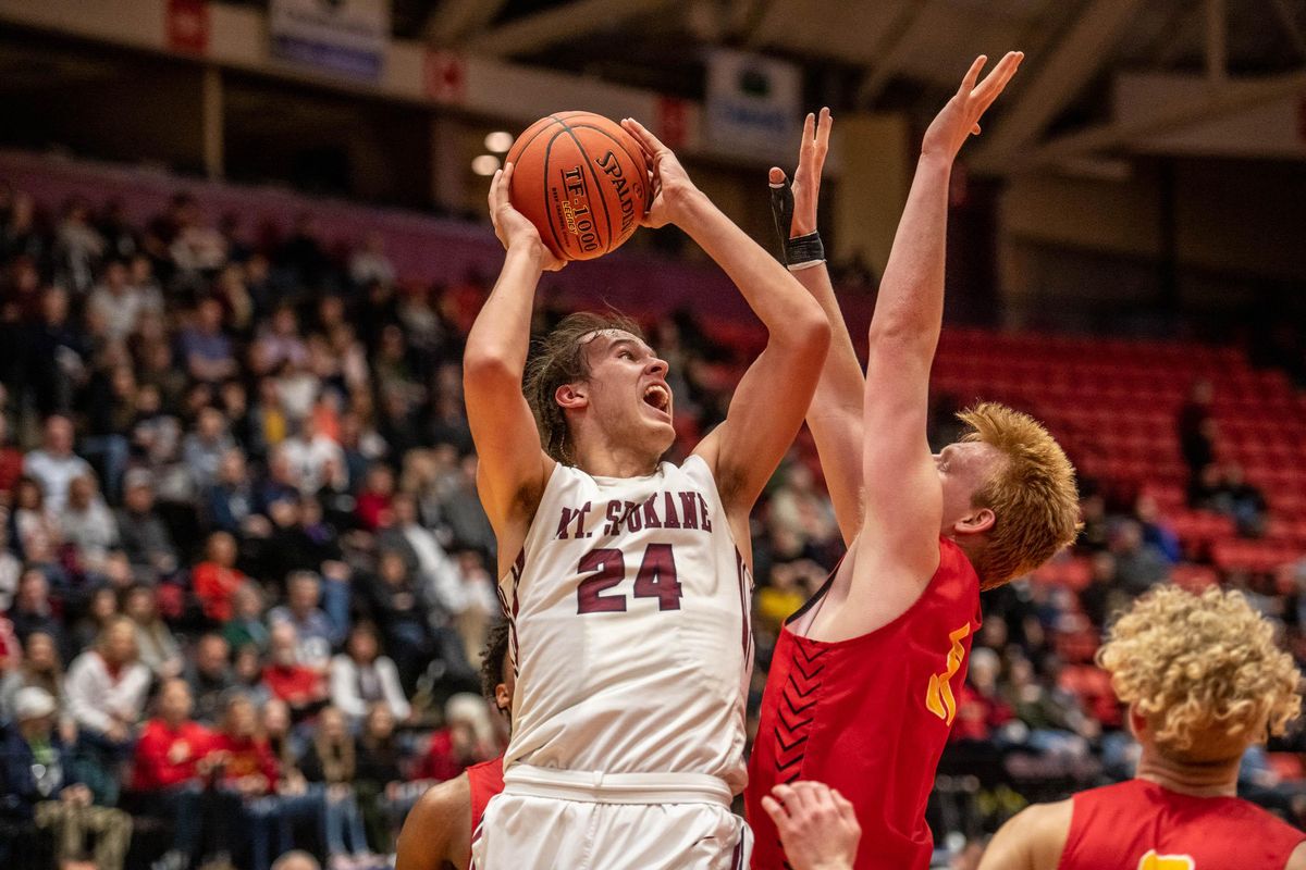 Mt. Spokane forward Tyson Degenhart (24) goes up for a shot while defended by Kamiakin