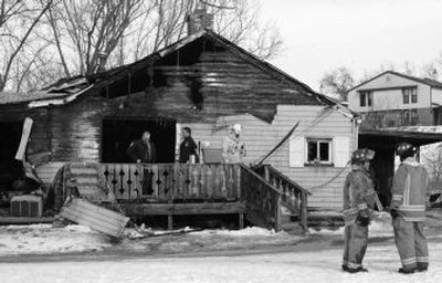 
Firefighters gather near a home in Waynesburg, Pa., where a fire swept through, killing six children and one woman Saturday. 
 (Associated Press / The Spokesman-Review)