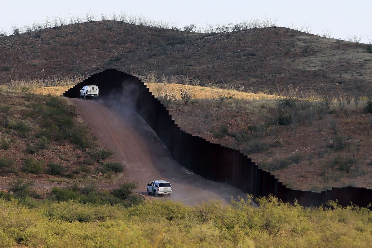 U.S. Border Patrol agents patrol the border fence near where a U.S. Border Patrol agent Nicholas Ivie was shot and killed, and one other was shot and injured, Tuesday, Oct. 2, 2012, in Naco, Ariz. (Ross Franklin / Associated Press)