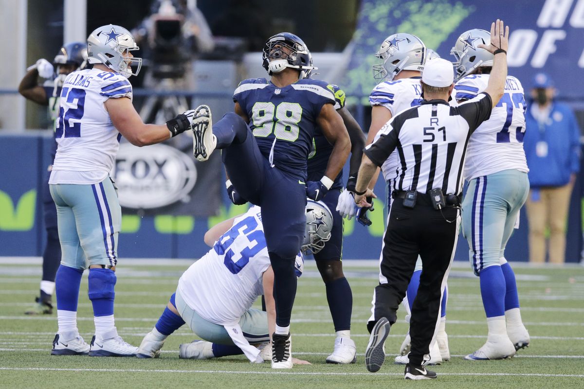 Seahawks defensive end Alton Robinson (98) celebrates a play during the second half of Seattle’s 38-31 win over Dallas on Sunday.  (John Froschauer)