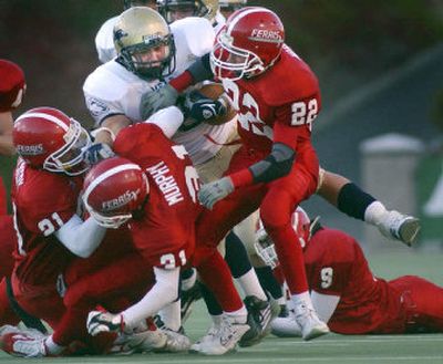 
Ferris defenders gang up on Mead running back Skylar Jessen after a 12-yard gain on Friday night in Greater Spokane League play at Albi Stadium.
 (Brian Plonka / The Spokesman-Review)