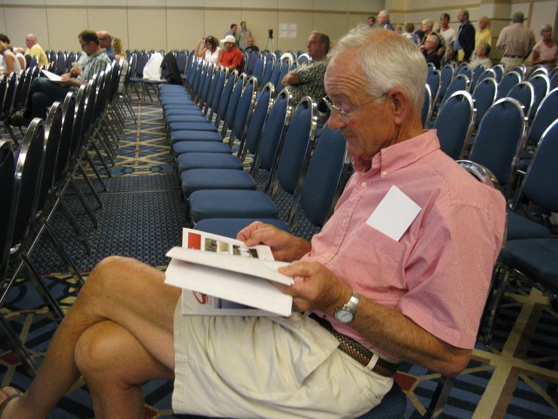 Steve Hubbs looks over the bidder's packet before the start of the Priest Lake cabin-site auction at the Coeur d'Alene Resort on Thursday (Betsy Russell)