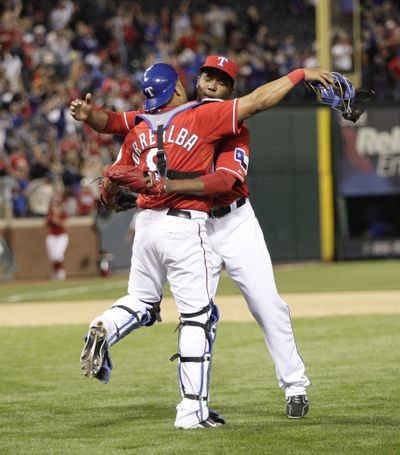 Texas catcher Yorvit Torrealba hugs closer Neftali Feliz after defeating Seattle. (Associated Press)