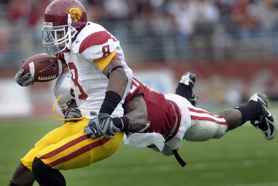 Washington State’s Chima Nwachukwu takes to the air in an attempt to stop USC running back Ronald Johnson during the first half.  (Christopher Anderson / The Spokesman-Review)