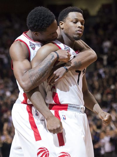 Toronto’s Kyle Lowry, right, is hugged by DeMar DeRozan after Lowry made the game-winning basket against the Cavaliers. (Nathan Denette / Associated Press)