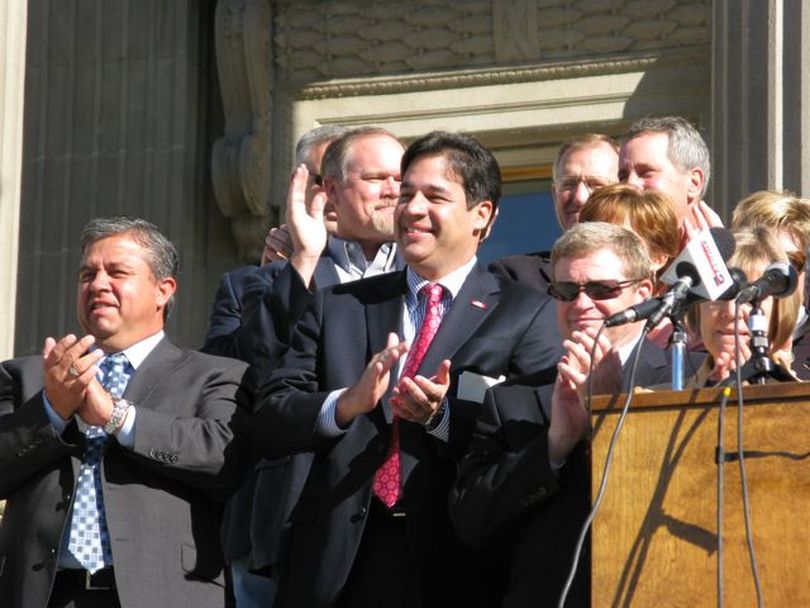 GOP congressman-elect Raul Labrador, center, applauds during a Republican rally on the state Capitol steps on Wednesday. At left is newly re-elected state Superintendent of Schools Tom Luna; at right is Attorney General Lawrence Wasden. (Betsy Russell)