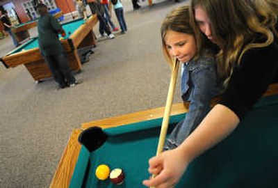 
Lexi Bass teaches Kiayia Jones how to shoot pool last week at the Boys & Girls Club of Spokane County. 
 (Rajah Bose / The Spokesman-Review)