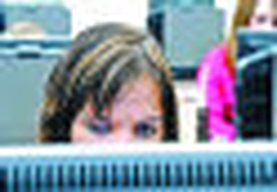 
Kellogg Middle School eighth-grader Tacey Day works on a computer at the school recently. Rural school districts such as hers depend on the federal Craig-Wyden program for a large portion of their funding. 
 (Kathy Plonka / The Spokesman-Review)